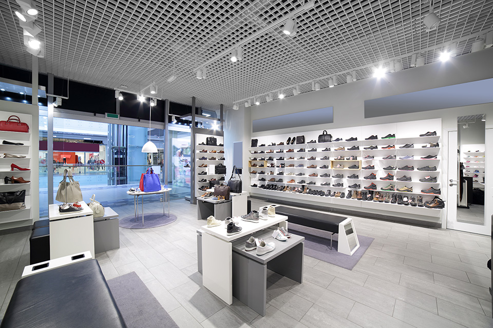 bright and fashionable interior of shoe store in modern mall