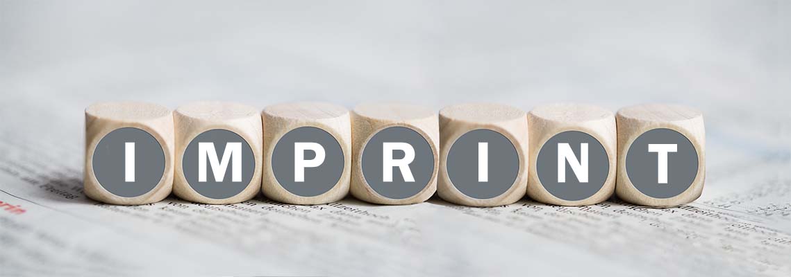 Cubes arranged on a newspaper with the word Imprint printed on them