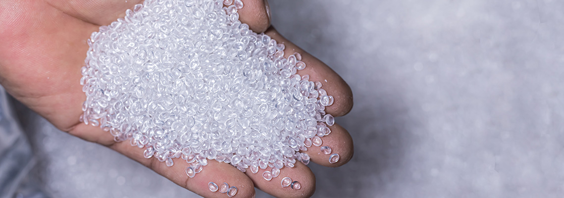hands holding a pile of plastic pellets, Plastic beads for factory