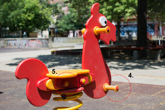 Red rocking horse with handles and sight caps for the playground