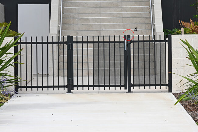 Fence with door and covering plugs in front of a house