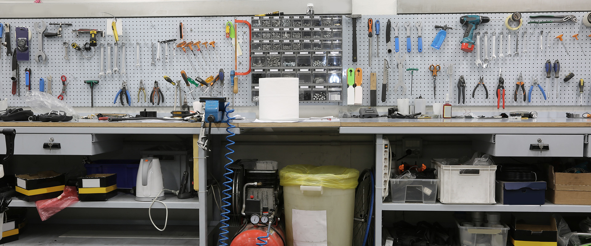 A workbench with a wide range of tools in a workshop specialising in bicycle repairs