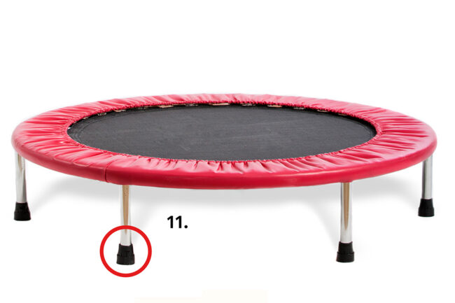 Red trampoline with a black jumping surface, isolated against a white background
