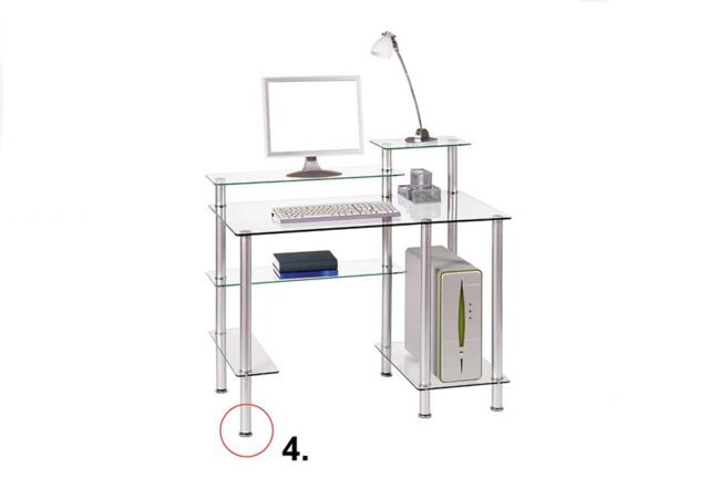 A modern desk with a glass top and a steel frame. On the desk is a computer screen with a keyboard, set against a white background